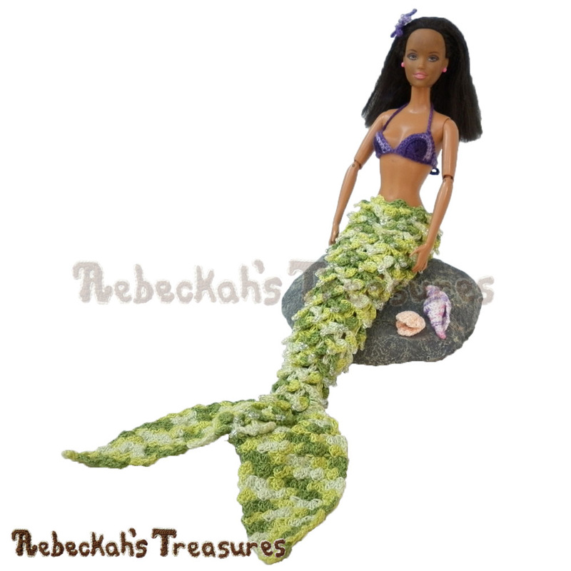 Fashion Doll Mermaid by @beckastreasures seated on a rock | Features a crocodile mermaid tail with beads, the halter loop swirls brassiere, a starfish hair piece & seashells!