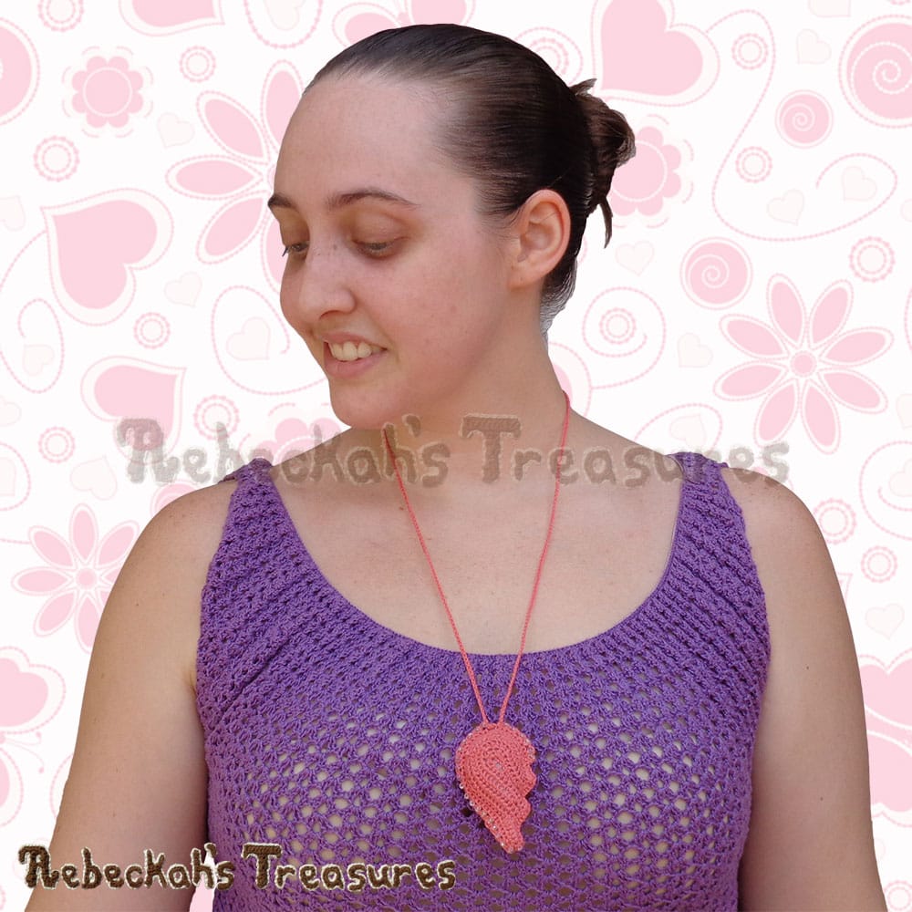 Me wearing the LEFT half of the Broken Hearts Dusty Rose Necklace! | Crochet Pattern by @beckastreasures for @getstuffed! | Will it be an amigurumi or an appliqué? Will it be a necklace, a fob or a pillow? Will the hearts be separated to share with your besties or kept whole to show broken hearts can be mended? YOU get to decide!!! | Available exclusively in #GetStuffedMagazine - the January 2017 issue - Get your copy today! | #crochet #pattern #brokenheart #valentine #heart #amigurumi #appliqué #necklace #fob #pillow