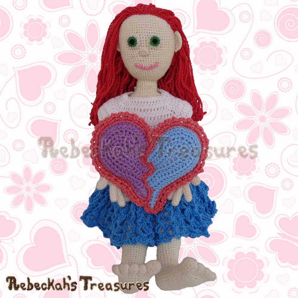 Style Me Dolly holding her NEW Broken Hearts Pillow! | Crochet Pattern by @beckastreasures for @getstuffed! | Will it be an amigurumi or an appliqué? Will it be a necklace, a fob or a pillow? Will the hearts be separated to share with your besties or kept whole to show broken hearts can be mended? YOU get to decide!!! | Available exclusively in #GetStuffedMagazine - the January 2017 issue - Get your copy today! | #crochet #pattern #brokenheart #valentine #heart #amigurumi #appliqué #necklace #fob #pillow
